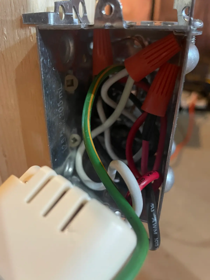 An electrical switch box is tightly packed with wires