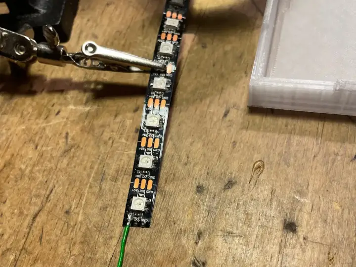 Soldering wires to the strip using a helping hand