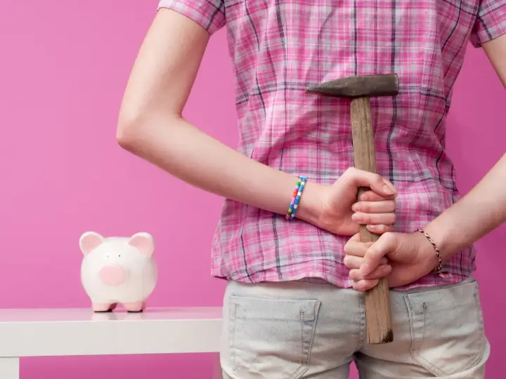 Breaking a piggy bank with a hammer